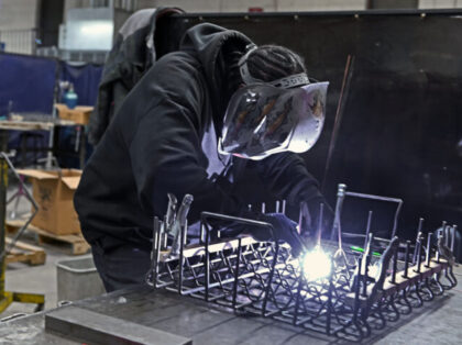Kellen Contee, a welder at Marlin Steel Wire in West Baltimore, works on a steel basket fo