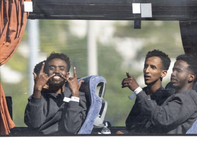 People believed to be migrants leaving by bus in Dover, Kent, following small boat crossin