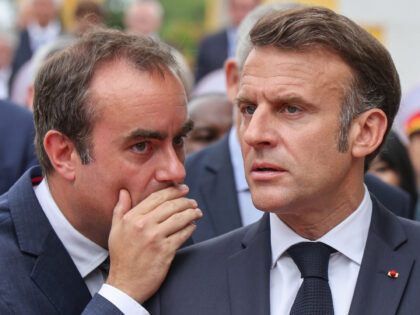 TOPSHOT - France's President Emmanuel Macron (R) speaks with France's Minister of Armed Fo