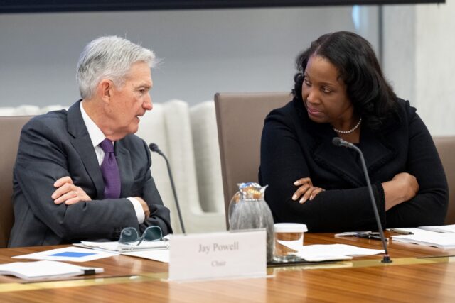 Chairman of the US Federal Reserve Jerome Powell speaks with Lisa Cook, member of the Boar