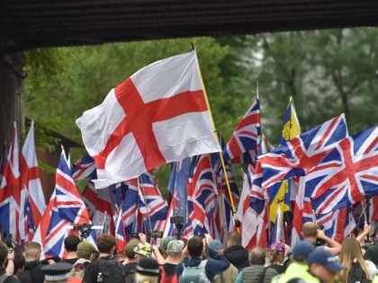 Far-right Britain First party supporters carry Union Flags and St George Cross flags durin