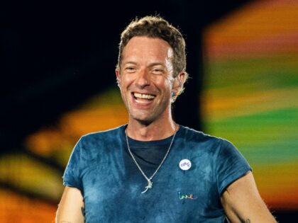 Chris Martin of Coldplay performs onstage during a concert at Wembley Stadium on August 22