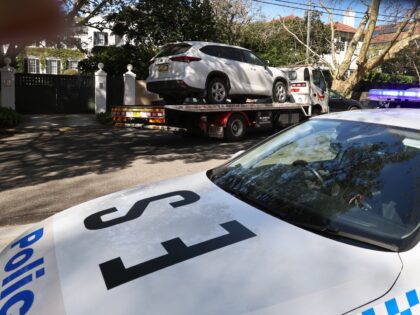 A tow truck removes a car after it was driven into the gates of the Russian consulate in S