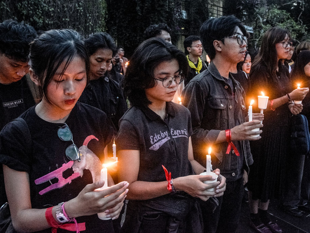 GettyImages-2232768505 Students hold candles at the Bandung Institute of Technology (ITB) in Bandung, West Java o