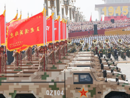 Hero units' banner formation marches through Tian'anmen Square during a military parade in