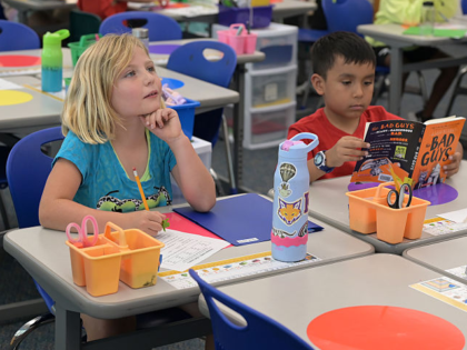 DENVER, CO - SEPTEMBER 3 : Cada Jones, left, and third grade students complete noun and ve