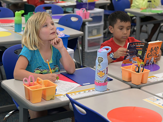 GettyImages-2232925830 DENVER, CO - SEPTEMBER 3 : Cada Jones, left, and third grade students complete noun and ve
