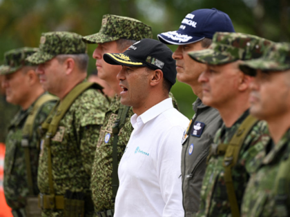 Colombian Defense Minister Pedro Sanchez (C) gives instructions to soldiers during his vis