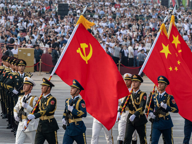 BEIJING, CHINA - SEPTEMBER 3: Chinese soldiers march with the national flag, the flag of t