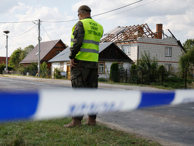 Police and army inspect damage to a house destroyed by debris from a shot down Russian dro