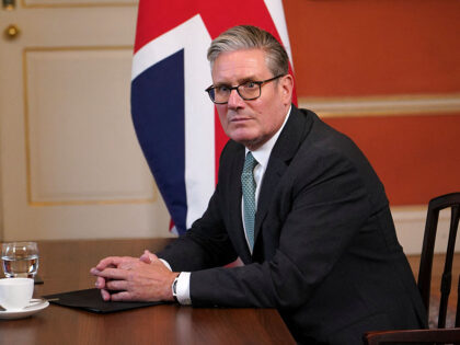 Britain's Prime Minister Keir Starmer sits at a table at the start of his meeting wit