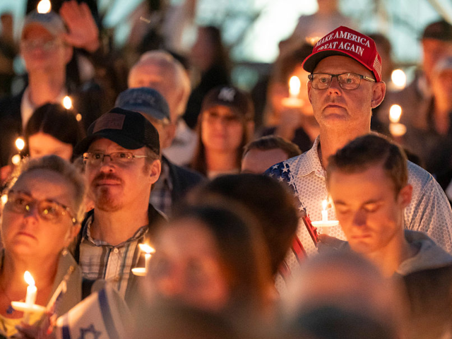 GettyImages-2234134594 SEATTLE, WASHINGTON - SEPTEMBER 10: Attendees hold candles during a candlelight vigil and