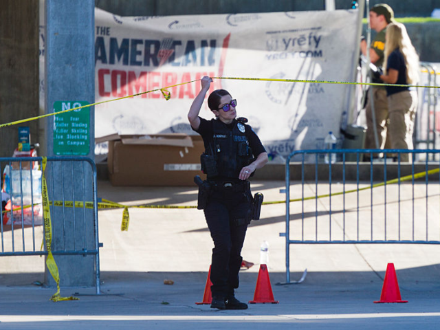 GettyImages-2234179531 OREM, UTAH - SEPTEMBER 11: Police officers and FBI agents walk through the courtyard at Ut