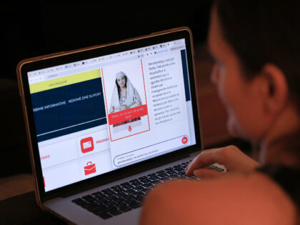 A woman looks at a computer as she uses the Albanian government portal "E - Albania", now