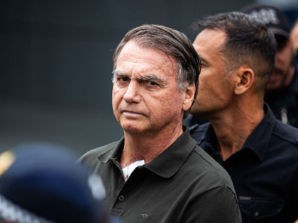 Jair Bolsonaro, Brazil's former president, center, departs from a scheduled surgery at the