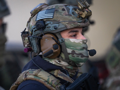 BROADVIEW, ILLINOIS - SEPTEMBER 12: Federal law enforcement agents watch as demonstrators