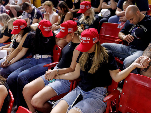 GettyImages-2235154035 TEMPE, ARIZONA - SEPTEMBER 15: People pray at a vigil for Charlie Kirk at Arizona State Un