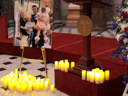 WASHINGTON, DC - SEPTEMBER 15: Electric candles are left near a photograph of conservative