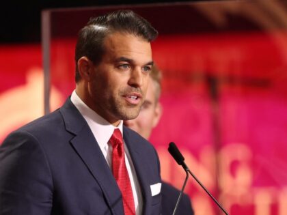 Andrew Kolvet, producer of The Charlie Kirk Show, speaks during the public memorial servic