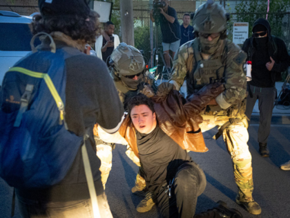 BROADVIEW, ILLINOIS - SEPTEMBER 19: A demonstrator is taken into custody following a clash