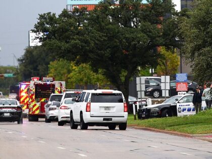 Law enforcement and emergency personnel respond near the scene of a shooting at a US Immig