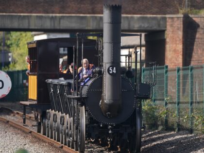 Train driver Chris Cubit rides on a replica of Locomotion No 1 during a test run for 'The