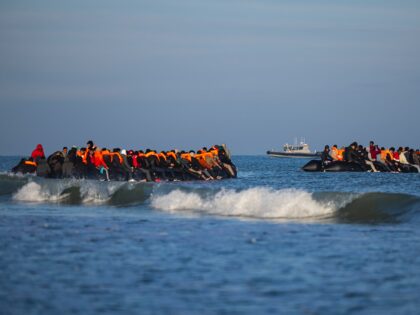 Migrants try to board smugglers' boats in an attempt to cross the English Channel off the