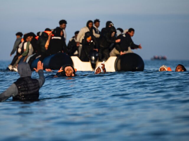 Migrants try to board smugglers' boats in an attempt to cross the English Channel off the