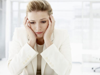 Businesswoman with head in hands
