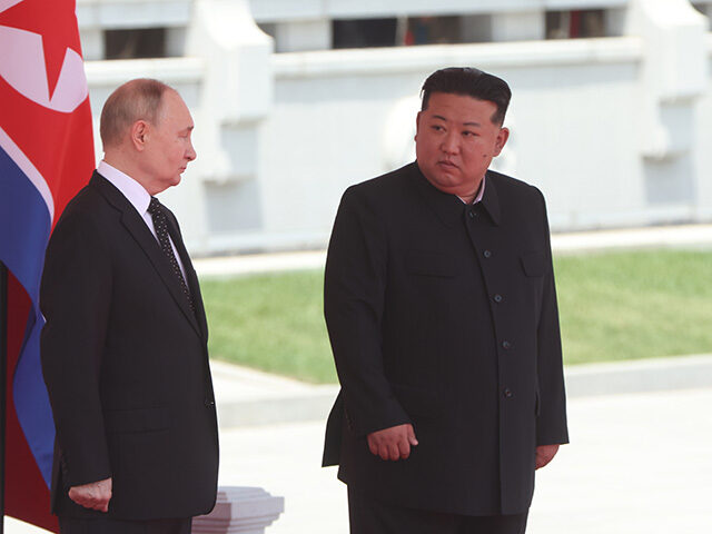 Russia's President Vladimir Putin (L) and North Korean Supreme Leader Kim Jong Un (R) atte