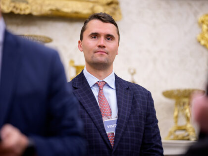 Turning Point USA co-founder Charlie Kirk stands in the back of the room as U.S. President