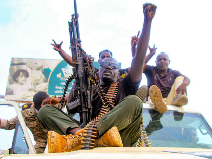 Sudanese army soldiers react during a military parade as part of religious commemorations