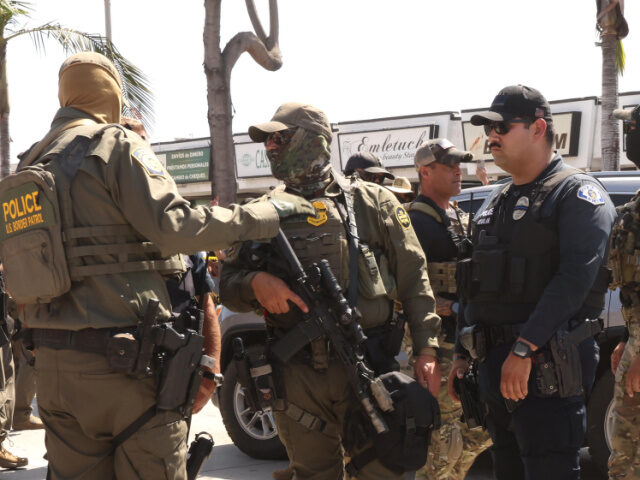 While being surrounded by angry residents, federal and Border Patrol agents plan their esc
