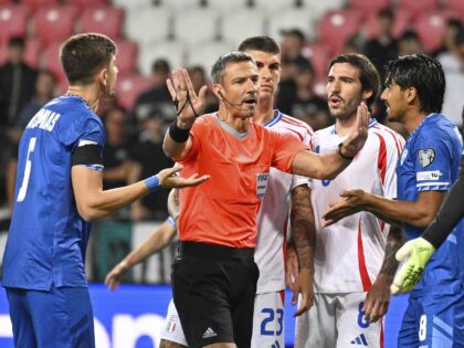 Players argue with referee Slavko Vincic during a Group I, World Cup qualifier soccer matc