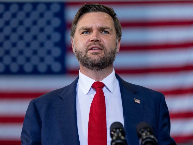 JD Vance speaking in front of a US Flag