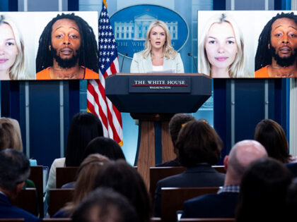White House Press Secretary Karoline Leavitt speaks alongside a photo of Ukrainian refugee