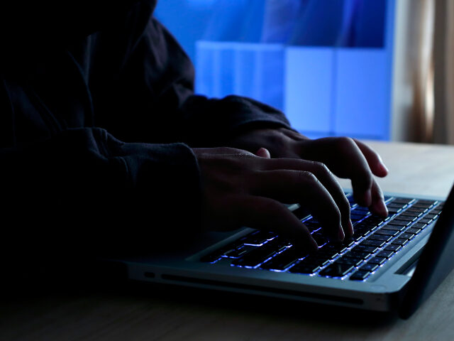 Man at keyboard in the dark