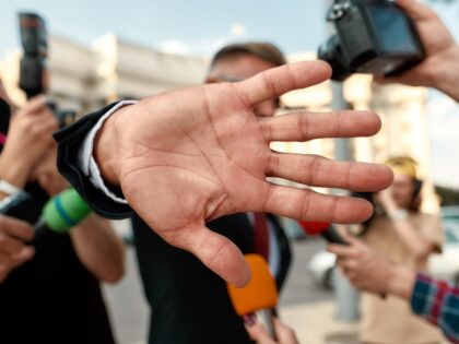 Man blocking camera lens