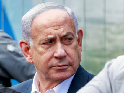 Israel's Prime Minister Benjamin Netanyahu visits the scene of a shooting at the Ramo