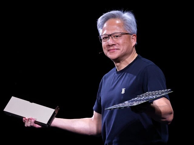 Nvidia CEO Jensen Huang holds his AI chips