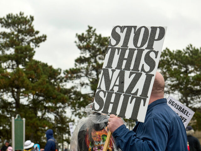 People affiliated with the 50501 movement gather at Hart Plaza in downtown Detroit, Michig