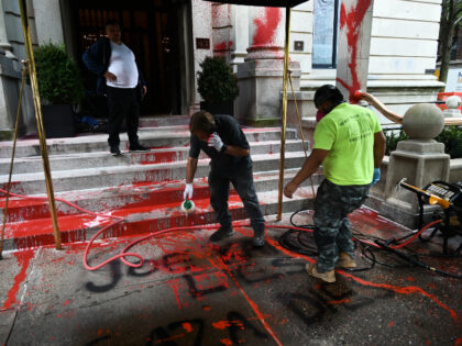 A view of the red paint splattered across the front steps, walls, sidewalk and lamps outsi