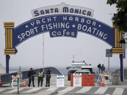 Police officers oversee a temporary closure of the Santa Monica Pier as part of measures t
