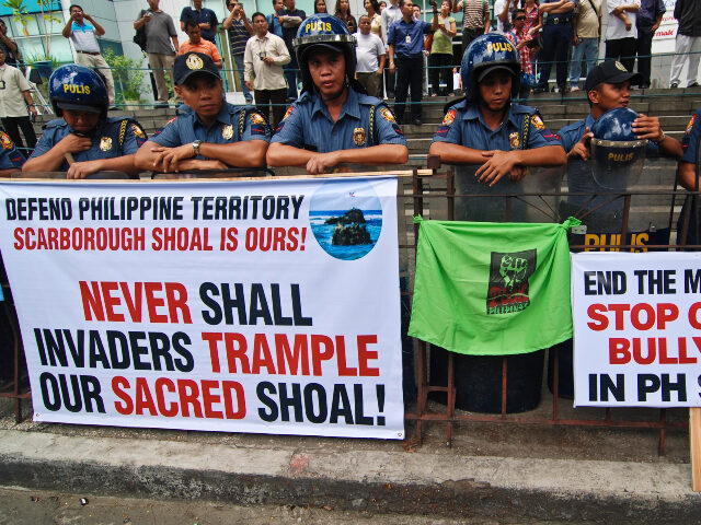 Philippine police stand guard at an anti China rally outside the Chinese Embassy in Makati