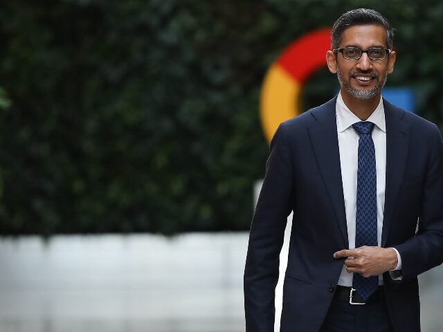 Sundar Pichai in front of the Google logo