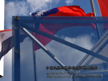 The national flags of Paraguay (L) and Taiwan wave outside the Taiwanese embassy in Asunci