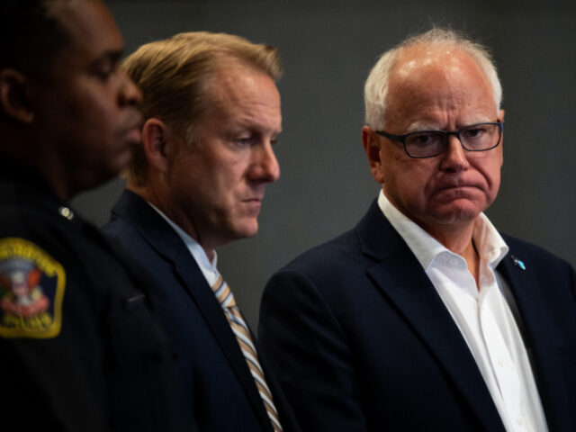 Tim Walz, Guns, Gun Control Minnesota Governor Tim Walz (R) listens during a press conference regarding new gun legisl