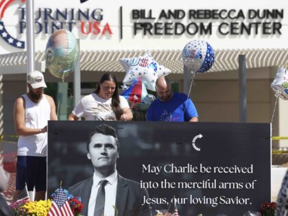 Well-wishers add balloons to a makeshift memorial set up at Turning Point USA headquarters