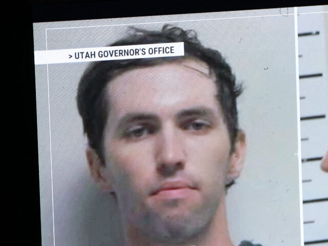 A TV monitor displays a picture of Tyler Robinson, the suspected of killing Charlie Kirk o