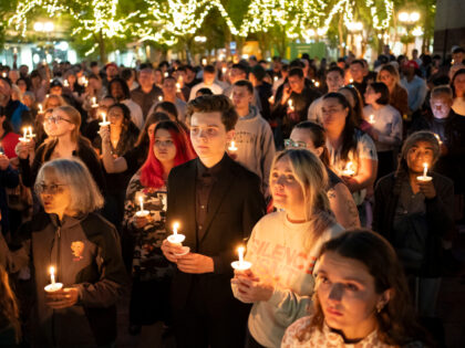 Attendees hold candles during a candlelight vigil and prayer event for Turning Point USA F